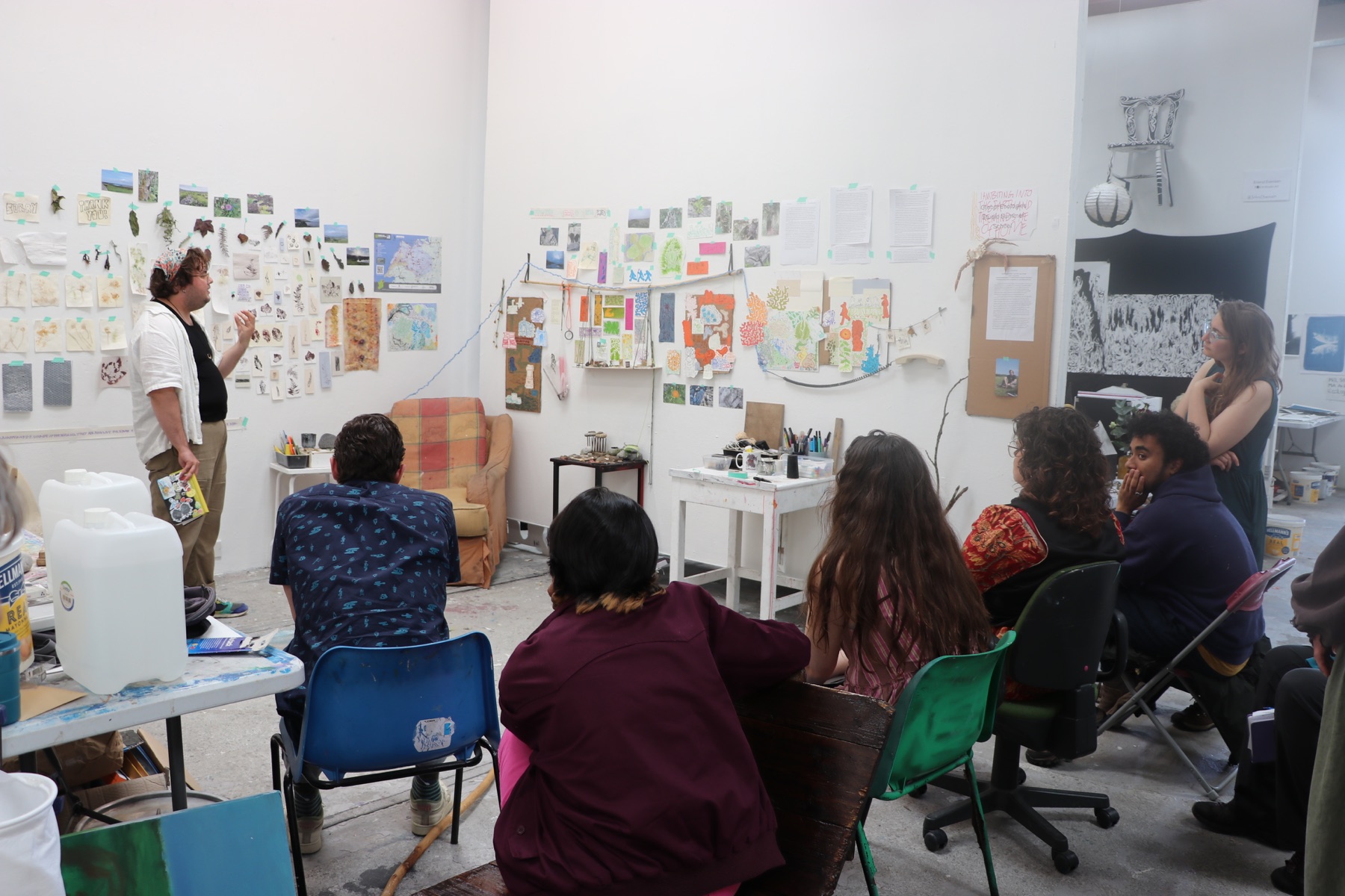 Students discussing research and artwork in a shared studio