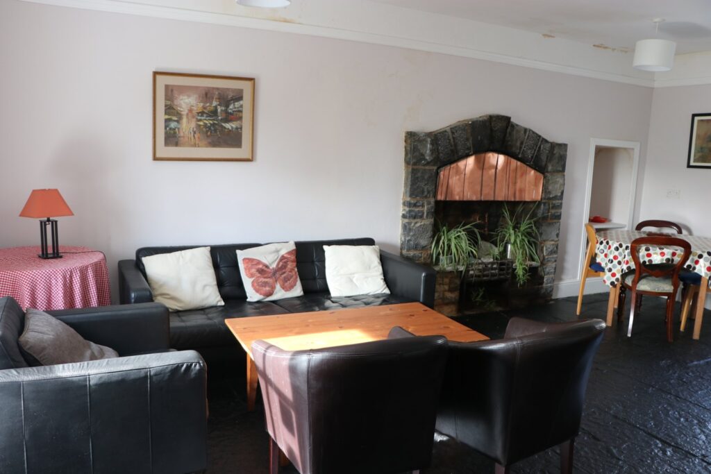 Shared sitting room with fireplace in Newtown House