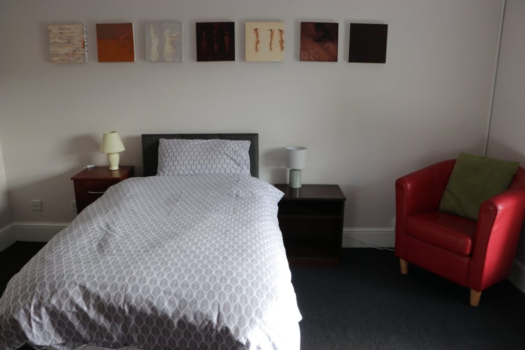 Bedroom with a red armchair in Newtown House
