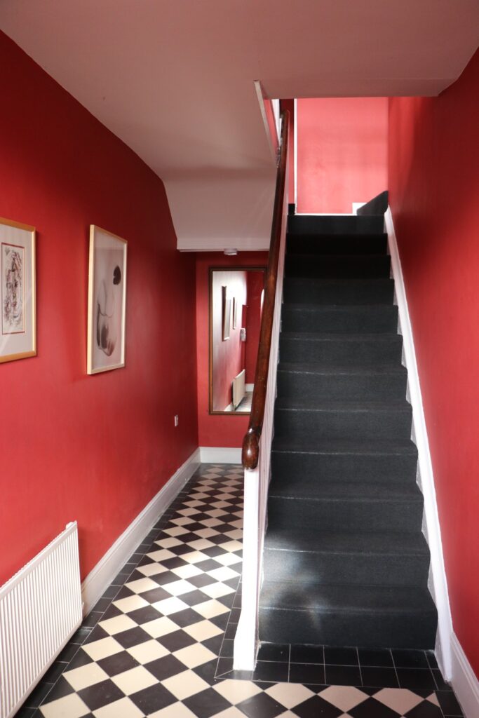 Red hallway and staircase in Newtown House